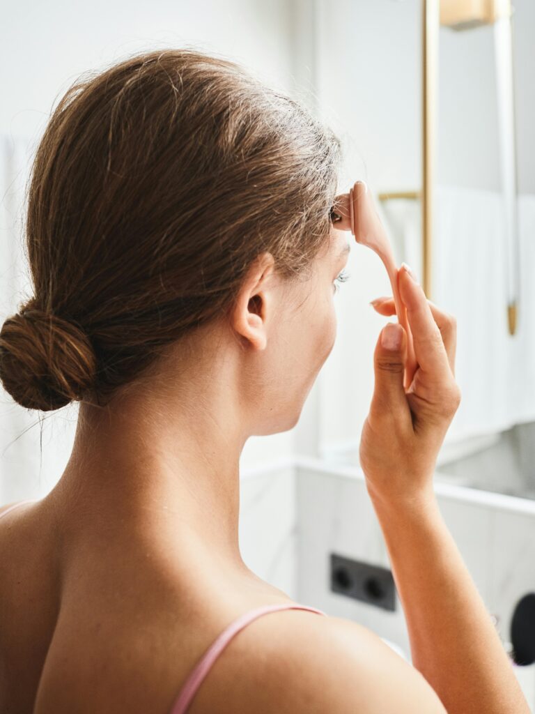 woman using beauty device at home