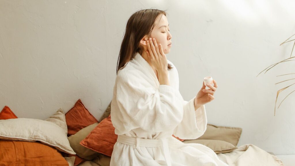 woman using gentle skincare to treat skin concerns at home